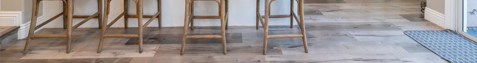 Bar seating on Home Top SPC flooring, showing plank layout and joint detail
